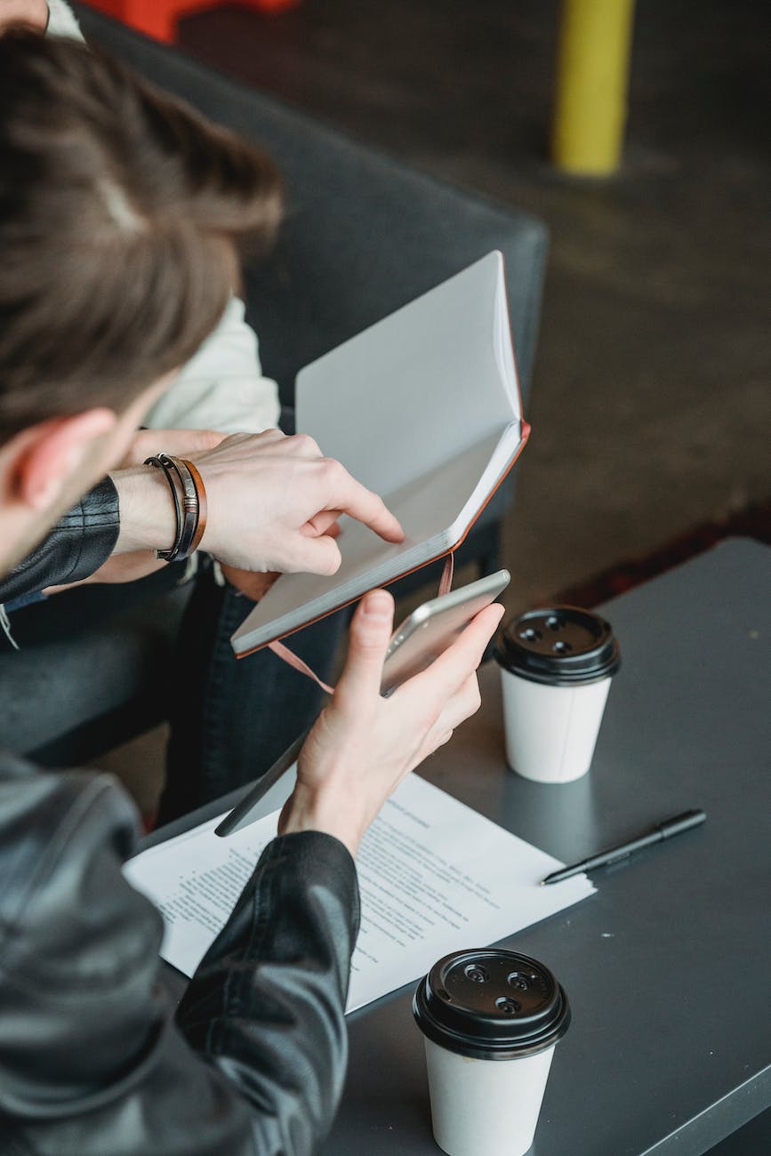 male colleagues working with documents in cafe